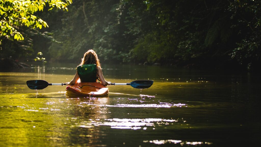 kayaking in a lake at sunset